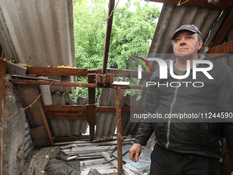 A displaced man from Avdiivka, Donetsk region, is being pictured in a house damaged by the falling debris of a Russian rocket in Dnipro, Ukr...