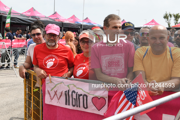 People showing a banner with typical Abruzzo arrosticini meat prior to the 107th Giro d'Italia 2024, Stage 12, a 193km stage from Martinsicu...