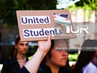 A girl holds United Students banner during solidarity with Palestine demonstration in front of Jagiellonian University building in Krakow, P...