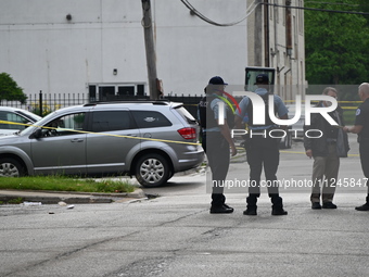 Police officers are gathering on the scene. A 26-year-old male victim is injured in a shooting in Chicago, Illinois, United States, on May 1...