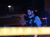 A police officer is overlooking the crime scene on Thursday evening. A 29-year-old male victim is dying after being shot multiple times in C...