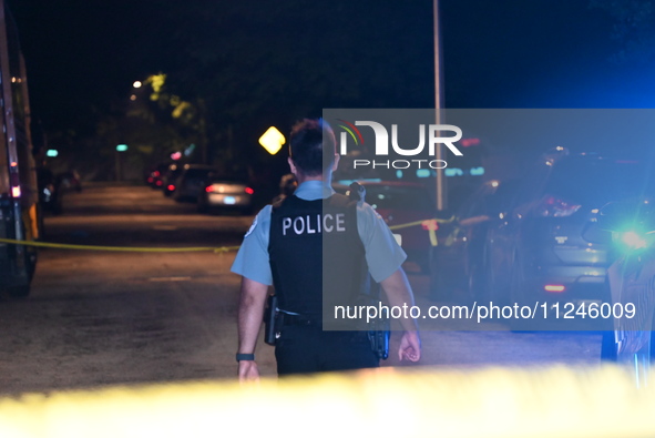 A police officer is overlooking the crime scene on Thursday evening. A 29-year-old male victim is dying after being shot multiple times in C...