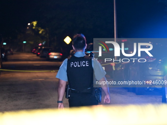 A police officer is overlooking the crime scene on Thursday evening. A 29-year-old male victim is dying after being shot multiple times in C...