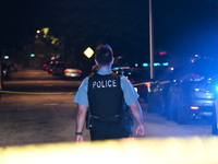 A police officer is overlooking the crime scene on Thursday evening. A 29-year-old male victim is dying after being shot multiple times in C...