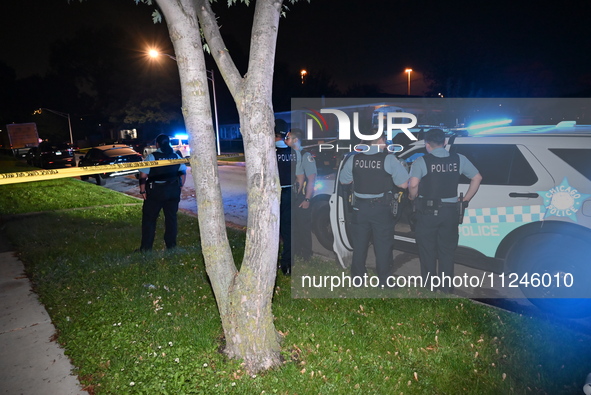 Police officers are gathering at the crime scene. A 29-year-old male victim is dying after being shot multiple times in Chicago, Illinois, U...