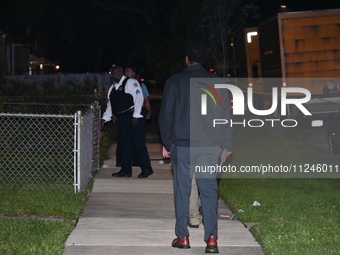 Police officers are gathering at the crime scene. A 29-year-old male victim is dying after being shot multiple times in Chicago, Illinois, U...