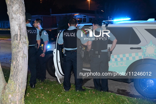 Police officers are gathering at the crime scene. A 29-year-old male victim is dying after being shot multiple times in Chicago, Illinois, U...