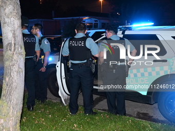 Police officers are gathering at the crime scene. A 29-year-old male victim is dying after being shot multiple times in Chicago, Illinois, U...