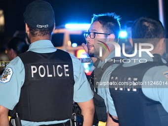 Police officers are gathering at the crime scene. A 29-year-old male victim is dying after being shot multiple times in Chicago, Illinois, U...