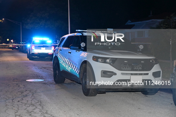 Police vehicles are at the crime scene on Thursday evening. A 29-year-old male victim is dying after being shot multiple times in Chicago, I...