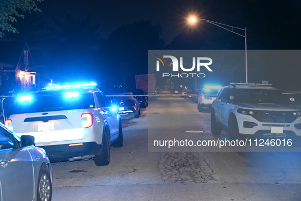 Police vehicles are at the crime scene on Thursday evening. A 29-year-old male victim is dying after being shot multiple times in Chicago, I...