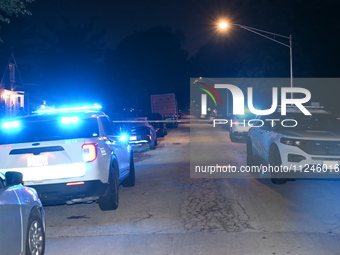 Police vehicles are at the crime scene on Thursday evening. A 29-year-old male victim is dying after being shot multiple times in Chicago, I...