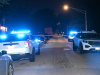 Police vehicles are at the crime scene on Thursday evening. A 29-year-old male victim is dying after being shot multiple times in Chicago, I...