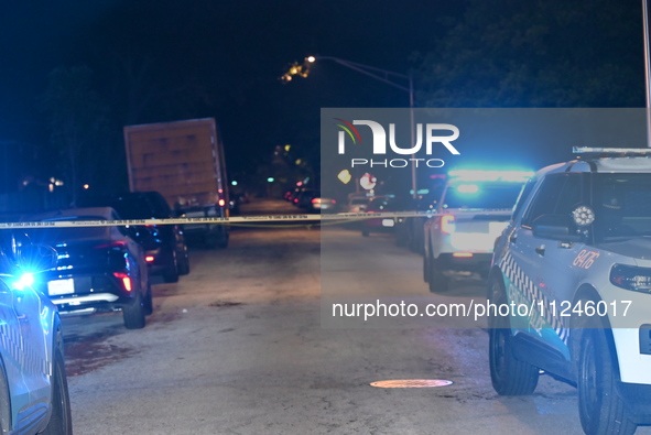 Police vehicles are at the crime scene on Thursday evening. A 29-year-old male victim is dying after being shot multiple times in Chicago, I...