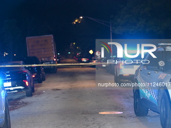 Police vehicles are at the crime scene on Thursday evening. A 29-year-old male victim is dying after being shot multiple times in Chicago, I...