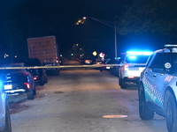 Police vehicles are at the crime scene on Thursday evening. A 29-year-old male victim is dying after being shot multiple times in Chicago, I...