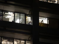 A worker is surveying the damage from inside 1001 Louisiana St. after the storm in Houston, Texas, on May 16, 2024. (