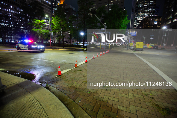 Streets are being blocked off by police as the cleanup crew is managing the aftermath of the storm in City, Country, on May 16, 2024. 