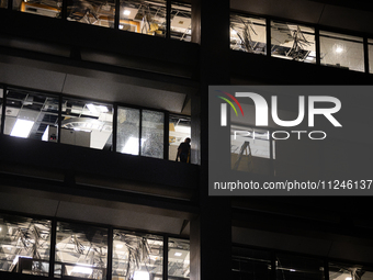 A worker is surveying the damage from inside 1001 Louisiana St. after the storm in Houston, Texas, on May 16, 2024. (