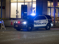 A police car is being seen on a downtown road covered in shattered glass after the storm in City, Country, on May 16, 2024. (