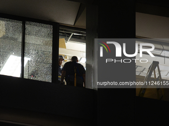 Workers are surveying the damage from inside 1001 Louisiana St. after the storm in Houston, Texas, on May 16, 2024. (