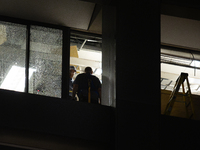 Workers are surveying the damage from inside 1001 Louisiana St. after the storm in Houston, Texas, on May 16, 2024. (