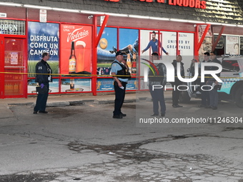 Police officers are at the scene. Three people are shot, with one person in critical condition in Chicago, Illinois, United States, on May 1...