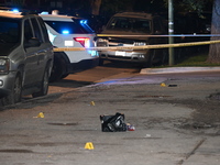 Evidence markers are being placed at the crime scene. Three people are being shot, and one person is in critical condition in Chicago, Illin...