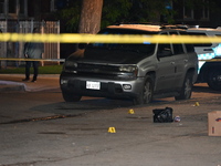 Evidence markers are at the crime scene. Three people are shot, and one person is in critical condition in Chicago, Illinois, United States,...