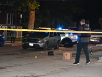 A police officer is at the crime scene. Three people are shot, with one person in critical condition in Chicago, Illinois, United States, on...