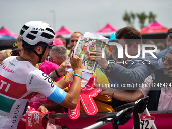 Mirco Maestri of Italy and Team Polti Kometa signing autographs to fans prior to the 107th Giro d'Italia 2024, Stage 12, a 193km stage from...