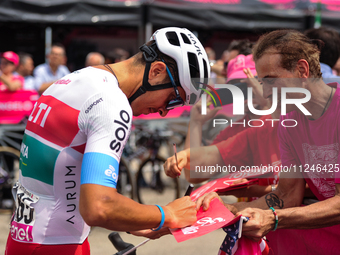 Mirco Maestri of Italy and Team Polti Kometa signing autographs to fans prior to the 107th Giro d'Italia 2024, Stage 12, a 193km stage from...