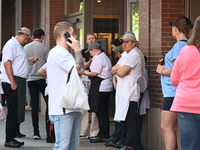 Workers of Eataly are gathering outside, wondering what is happening. There is a large police presence after an assault at Eataly Italian Re...