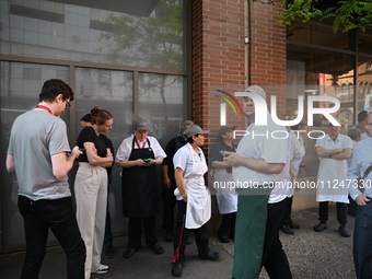 Workers of Eataly are gathering outside, wondering what is happening. There is a large police presence after an assault at Eataly Italian Re...