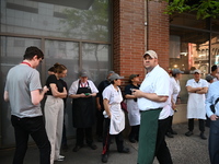 Workers of Eataly are gathering outside, wondering what is happening. There is a large police presence after an assault at Eataly Italian Re...