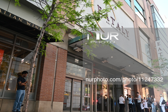 Workers of Eataly are gathering outside, wondering what is happening. There is a large police presence after an assault at Eataly Italian Re...