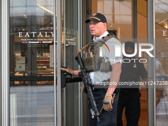 A police officer is exiting Eataly with a weapon. There is a large police presence after an assault at Eataly Italian Restaurant in Chicago,...