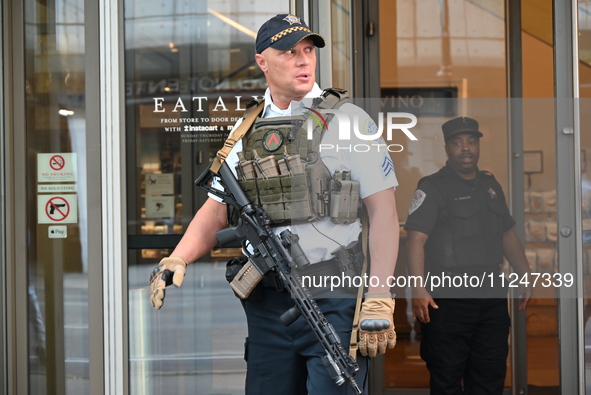 A police officer is exiting Eataly with a weapon. There is a large police presence after an assault at Eataly Italian Restaurant in Chicago,...