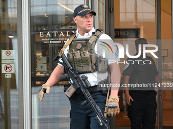 A police officer is exiting Eataly with a weapon. There is a large police presence after an assault at Eataly Italian Restaurant in Chicago,...