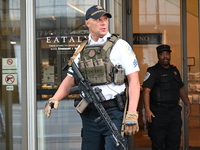 A police officer is exiting Eataly with a weapon. There is a large police presence after an assault at Eataly Italian Restaurant in Chicago,...