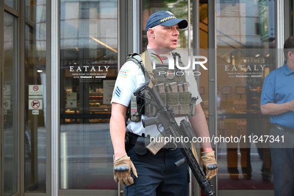 A police officer is exiting Eataly with a weapon. There is a large police presence after an assault at Eataly Italian Restaurant in Chicago,...