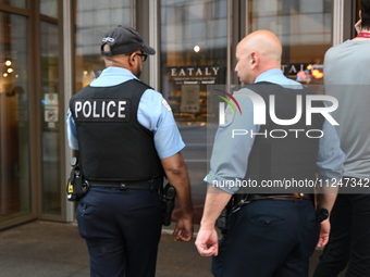 Police officers are entering Eataly. A large police presence is occurring after an assault at Eataly Italian Restaurant in Chicago, Illinois...