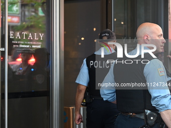 Police officers are entering Eataly. A large police presence is occurring after an assault at Eataly Italian Restaurant in Chicago, Illinois...