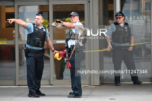 Police officers are taping off the front entrance to Eataly. There is a large police presence after an assault at Eataly Italian Restaurant...