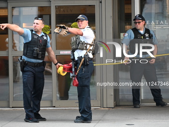 Police officers are taping off the front entrance to Eataly. There is a large police presence after an assault at Eataly Italian Restaurant...