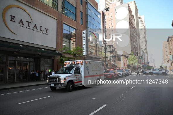 An ambulance is carrying the assault victim at the scene. A large police presence is observed after an assault at Eataly Italian Restaurant...