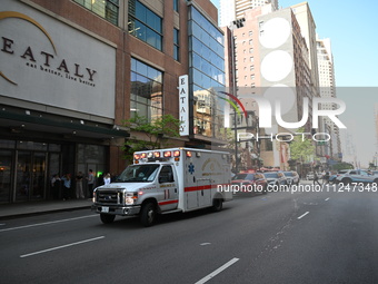 An ambulance is carrying the assault victim at the scene. A large police presence is observed after an assault at Eataly Italian Restaurant...