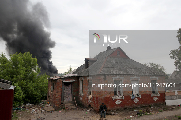 A pillar of smoke is rising from behind a house following the shelling of Russian troops in Kharkiv, Ukraine, on May 17, 2024. NO USE RUSSIA...