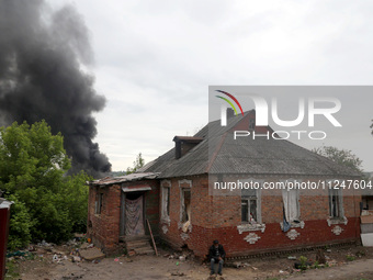 A pillar of smoke is rising from behind a house following the shelling of Russian troops in Kharkiv, Ukraine, on May 17, 2024. NO USE RUSSIA...