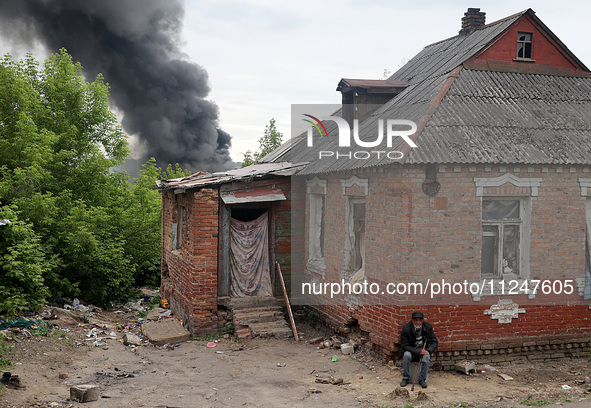 A pillar of smoke is rising from behind a house following the shelling of Russian troops in Kharkiv, Ukraine, on May 17, 2024. NO USE RUSSIA...